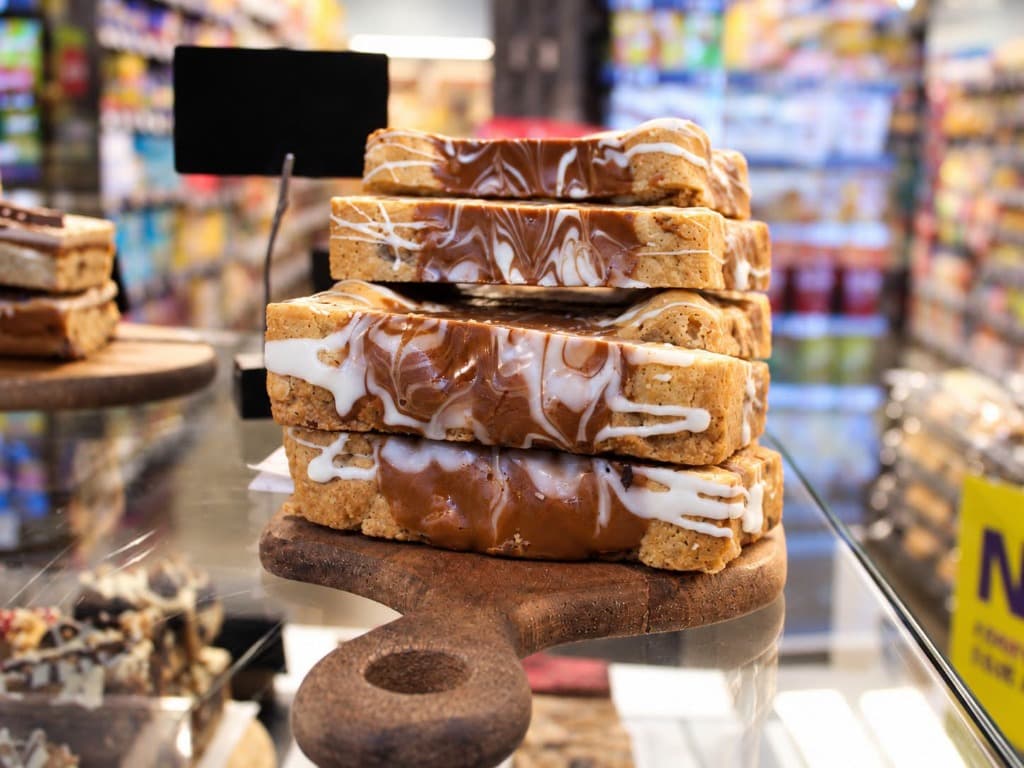 Triple 'a' Foodhall artisanal caramel fudge and marbled white chocolate bakery stack on wooden board